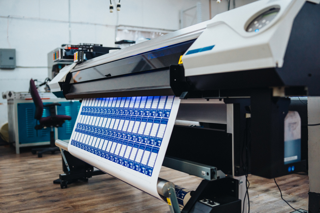 Professional Roland digital printer producing high-quality custom graphics and signage